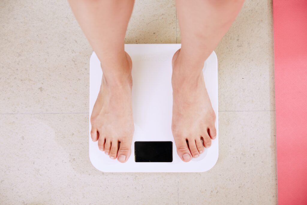 hypnotherapy for weight loss, woman on scales