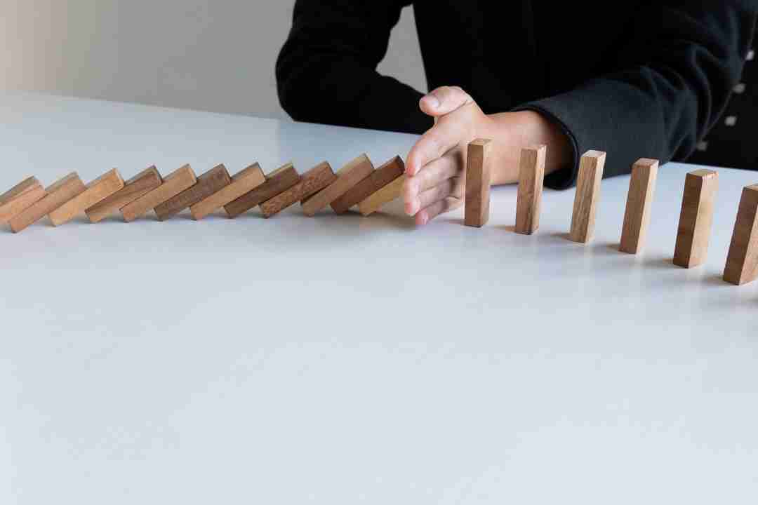 hypnosis uk, a hand stopping blocks from falling