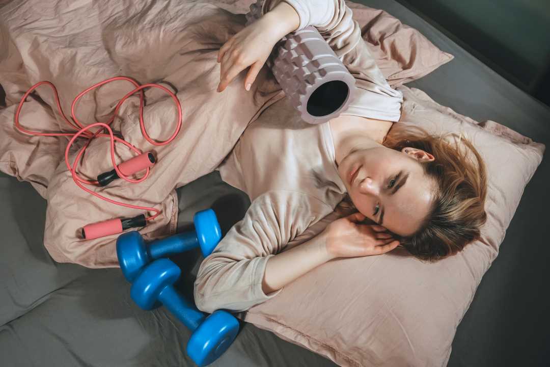 transform mentally, a woman in bed with exercise equipment