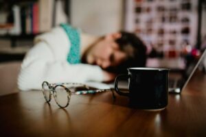 anxiety attacks, a sad woman on her desk