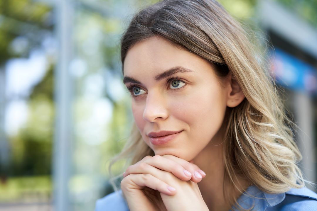 being assertive, a woman smiling with joined hands