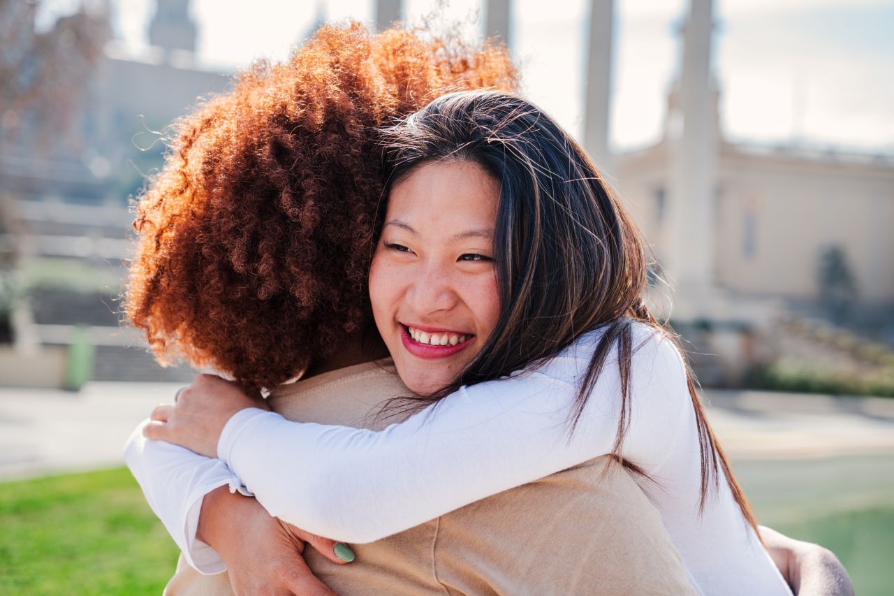 healing from emotional abuse, two happy girls hugging each other 