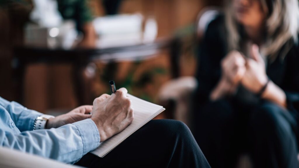 nail biting treatment, a therapist taking notes