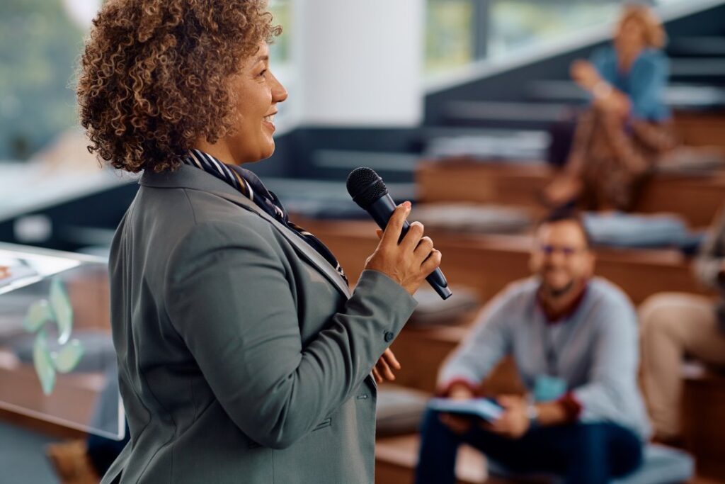 hypnotherapy for fear of public speaking, woman talking on stage