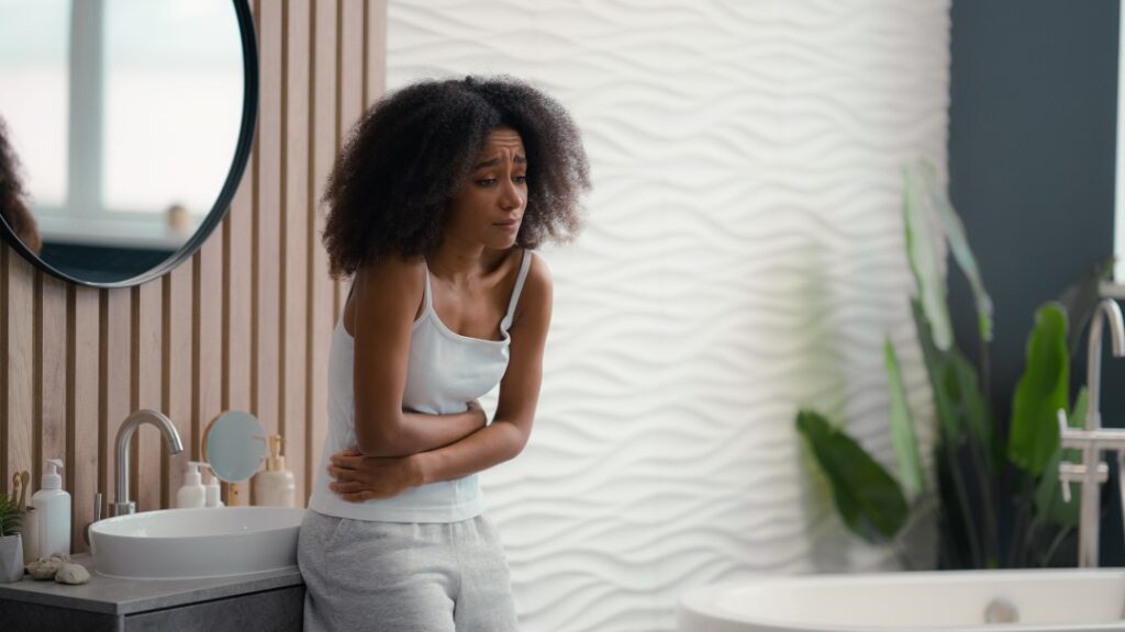 foods to avoid IBS gas, woman feeling stomach cramps